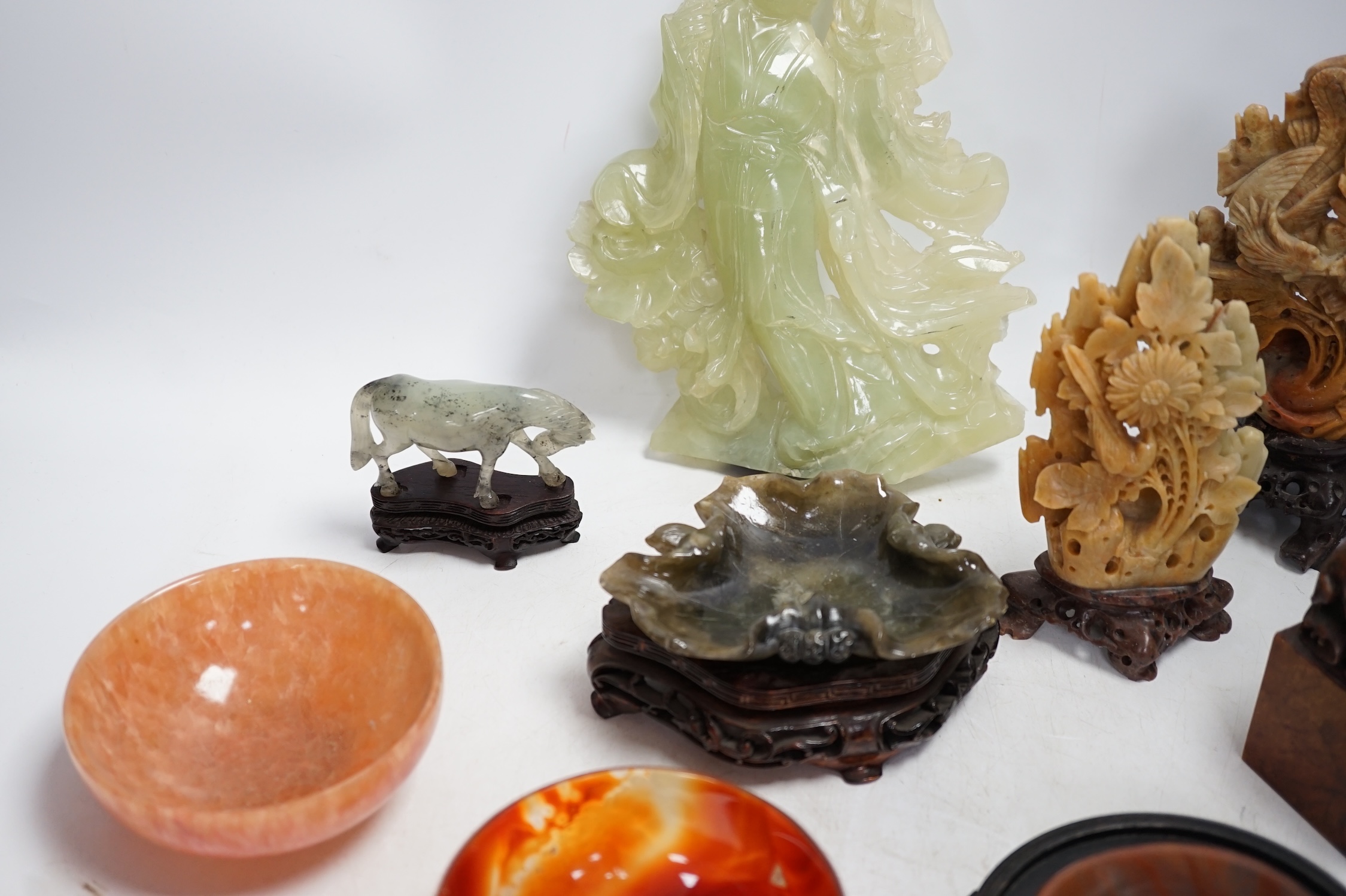A group of nine Chinese hardstone and soapstone figures, tallest 26cm. Condition - fair